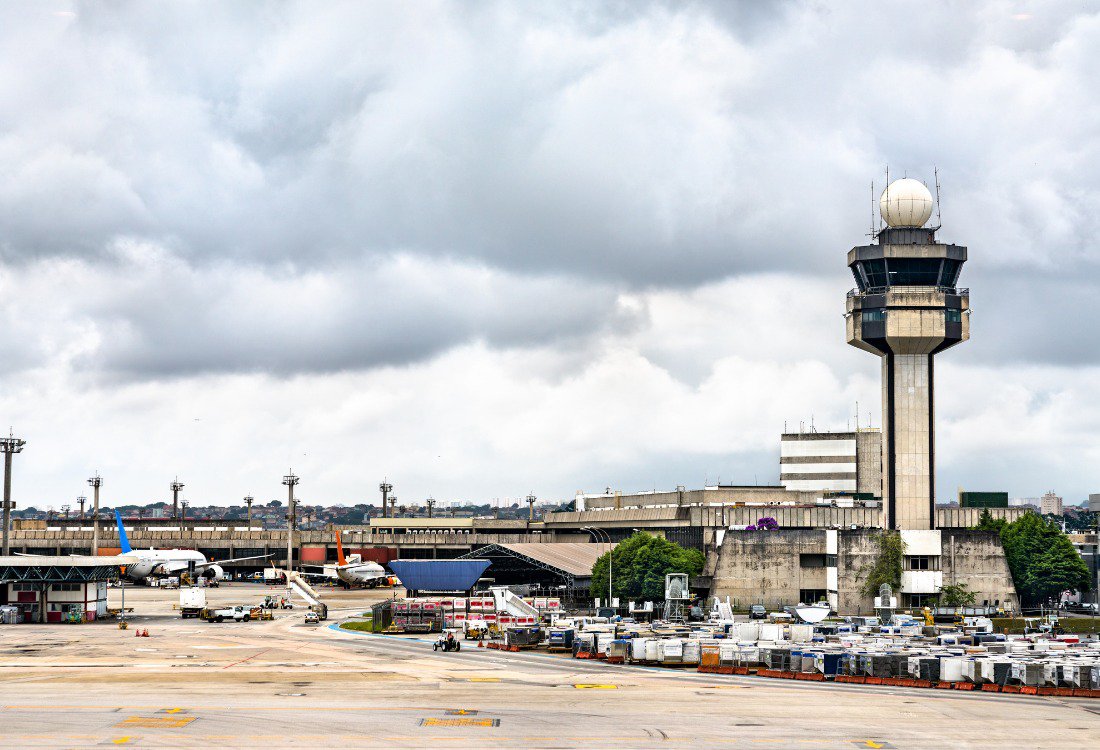 Cockpit Voice Recorder and Flight Data Recorder devices displayed with an airplane cockpit background, emphasizing their role in enhancing aviation safety. An airplane next to an ATC tower that uses cockpit voice recorders and flight data monitoring for enhanced safety.