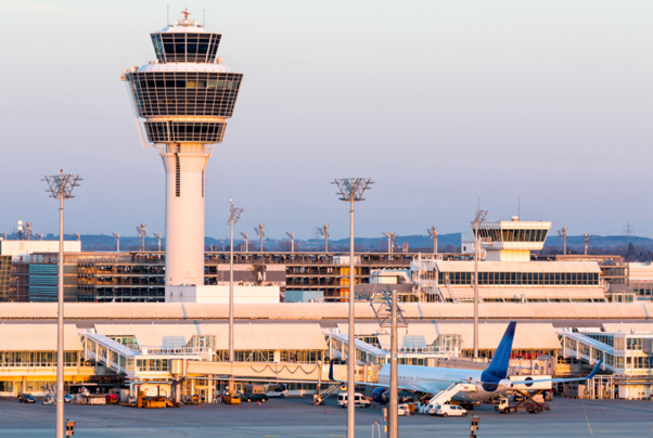 Air traffic control tower overseeing airport operations, representing System Wide Information Management and the future of aviation data exchange.